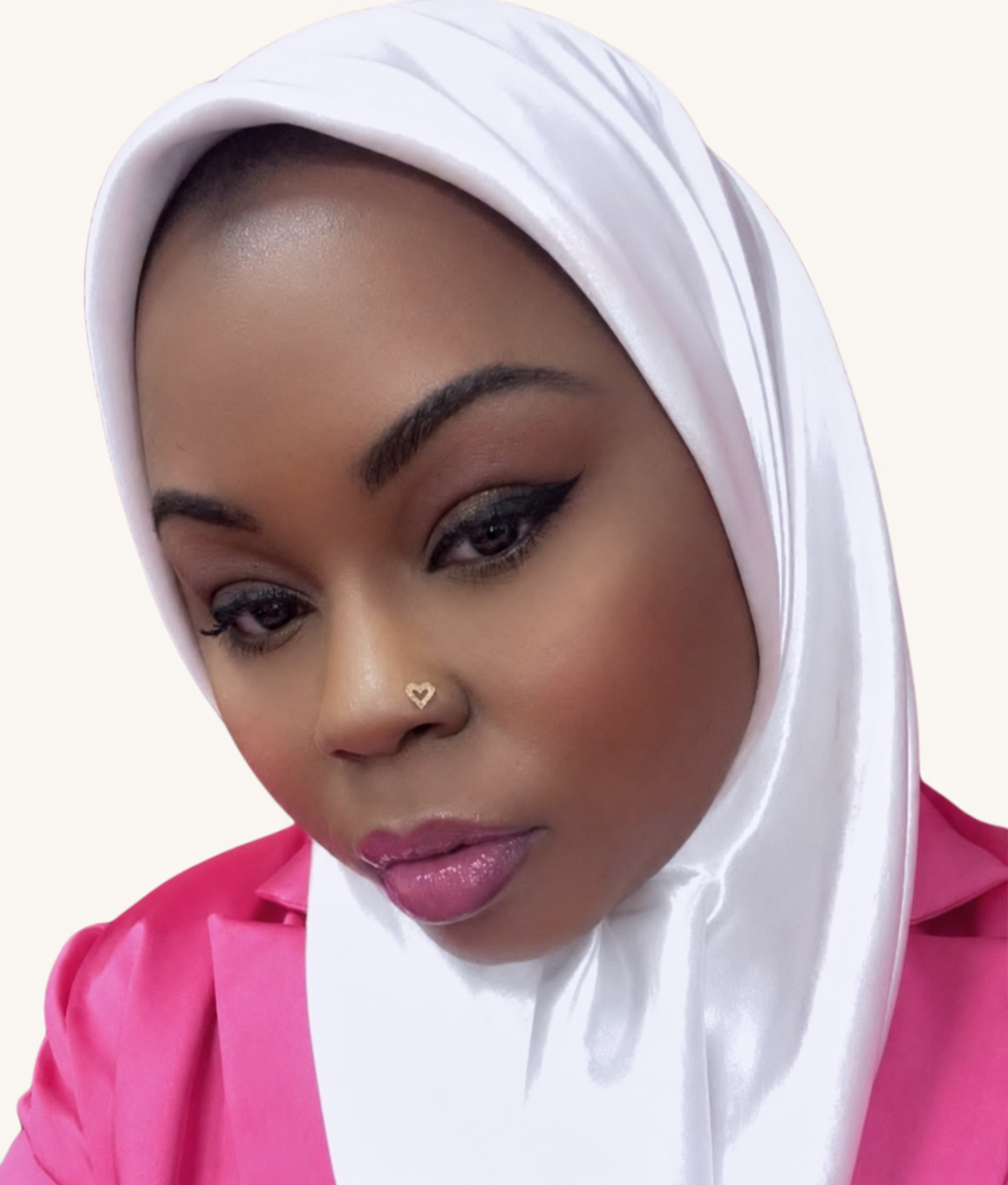 Jaquanah M. Williams, founder of IDentity X Her, wearing a white hijab and pink blazer against an ivory background